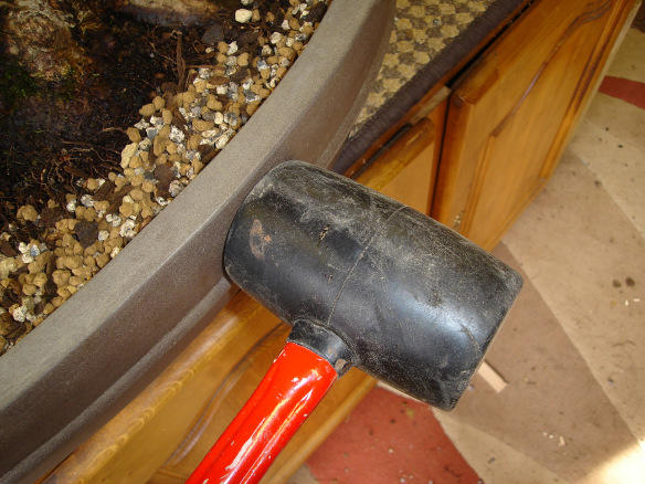 Hit the pot with a rubber mallet